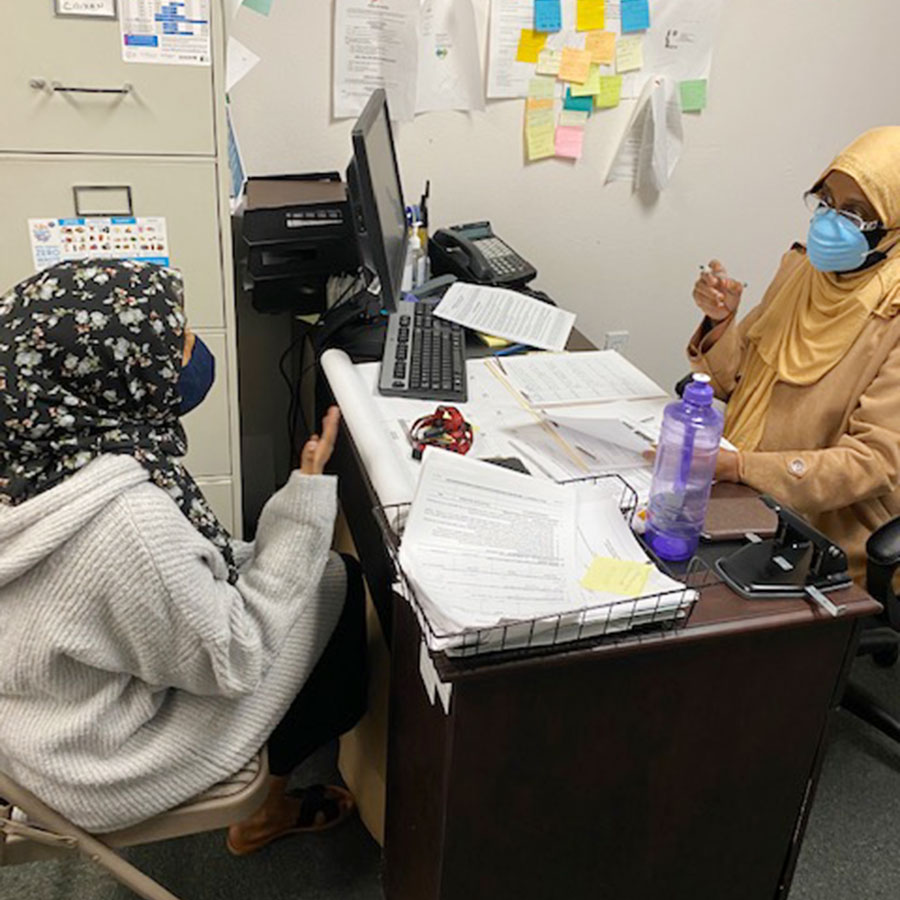 A Somali family childcare provider receives assistance with applying for a grant